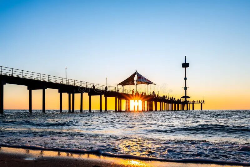 Adelaide jetty at sunset over the ocean